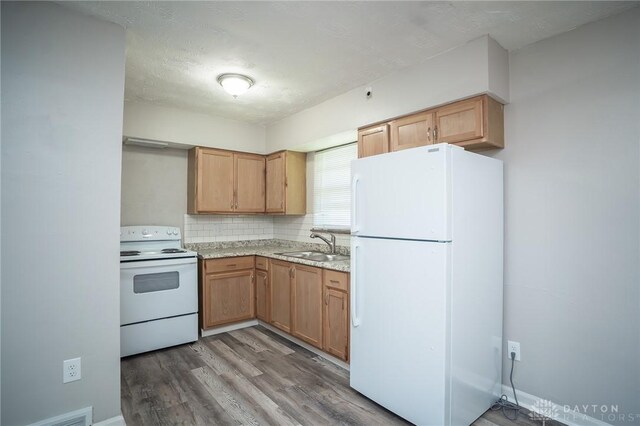 2525 Lakeview Ave, Dayton, OH 45417 - kitchen with white appliances, a sink, light wood-type flooring, decorative backsplash, and light stone counters