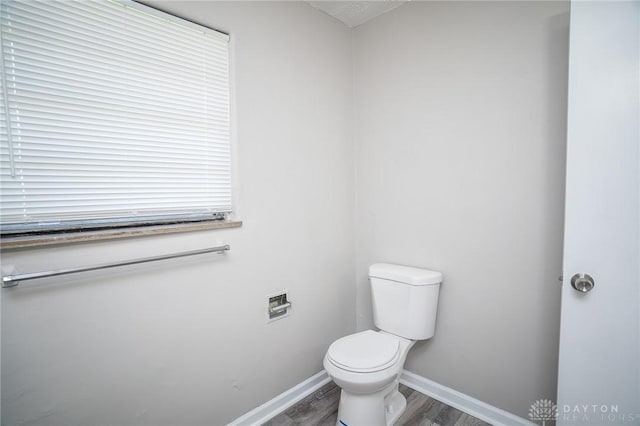 2525 Lakeview Ave, Dayton, OH 45417 - half bathroom with wood finished floors, toilet, and baseboards