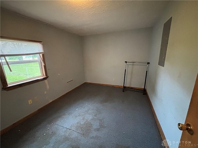 616 N Main St, Ansonia, OH 45303 - unfurnished room with baseboards, carpet, electric panel, and a textured ceiling