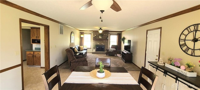 6765 Montpellier Blvd, Centerville, OH 45459 - dining area with a ceiling fan, a brick fireplace, ornamental molding, and baseboards