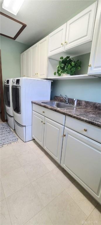 6765 Montpellier Blvd, Centerville, OH 45459 - laundry area featuring cabinet space, washing machine and clothes dryer, and light tile patterned flooring