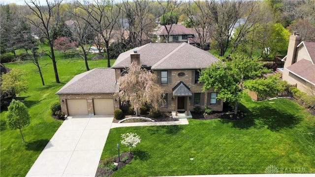 6765 Montpellier Blvd, Centerville, OH 45459 - view of front of home with an attached garage, concrete driveway, a front yard, and a shingled roof