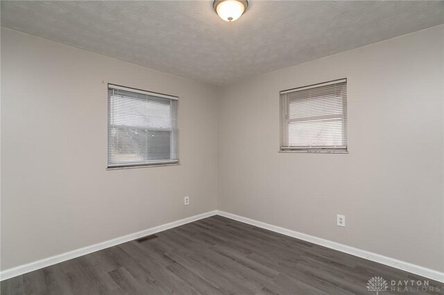 2525 Germantown St, Dayton, OH 45417 - spare room with dark wood-style flooring, baseboards, and a textured ceiling