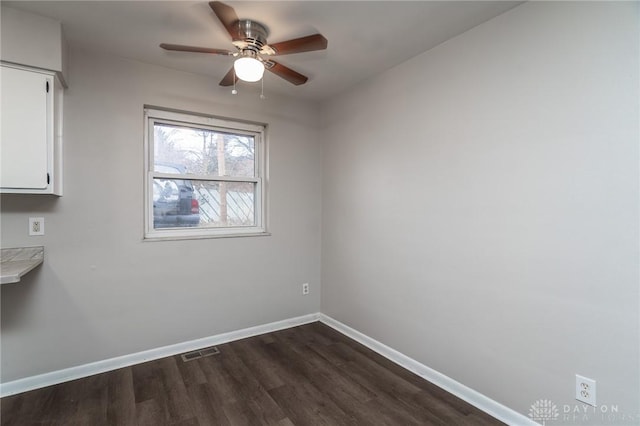 2525 Germantown St, Dayton, OH 45417 - empty room with dark wood finished floors, ceiling fan, and baseboards