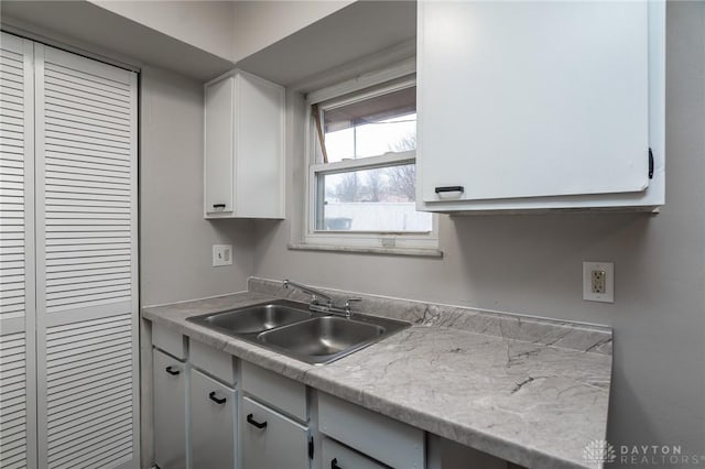 2525 Germantown St, Dayton, OH 45417 - kitchen with a sink, light countertops, and white cabinetry