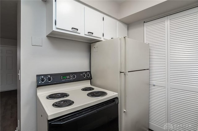 2525 Germantown St, Dayton, OH 45417 - kitchen featuring electric range oven, white cabinets, freestanding refrigerator, and light countertops
