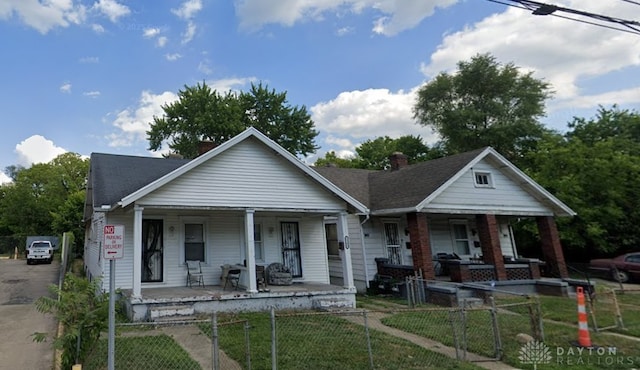 bungalow-style home with a porch, a fenced front yard, a gate, and roof with shingles