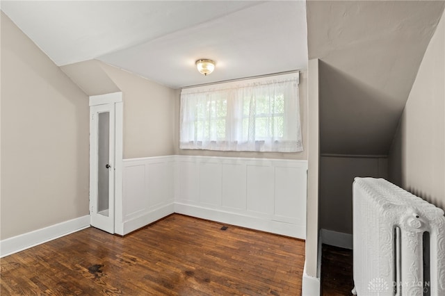 654 S Market St, Troy, OH 45373 - bonus room with radiator, lofted ceiling, dark wood finished floors, and a wainscoted wall