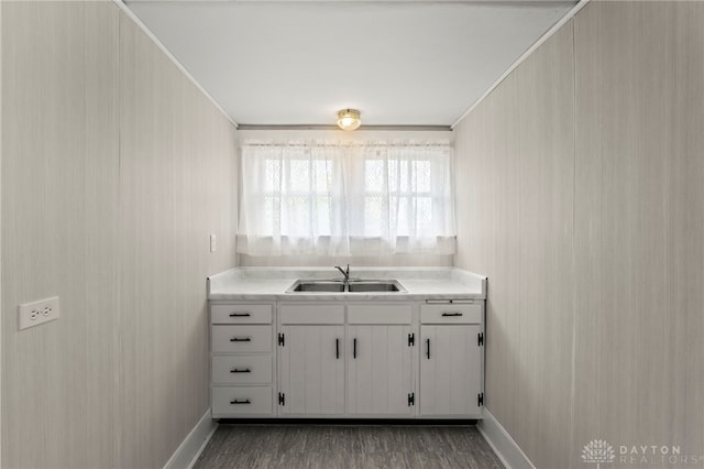 654 S Market St, Troy, OH 45373 - kitchen with a sink, baseboards, ornamental molding, light countertops, and wood finished floors