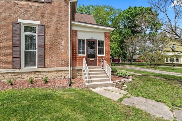 654 S Market St, Troy, OH 45373 - doorway to property featuring a yard and brick siding