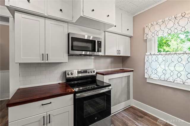 654 S Market St, Troy, OH 45373 - kitchen with appliances with stainless steel finishes, butcher block counters, decorative backsplash, dark wood-style flooring, and baseboards