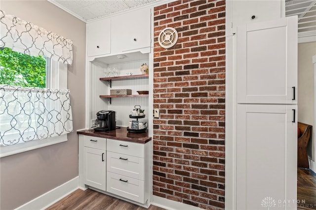 654 S Market St, Troy, OH 45373 - kitchen with dark wood-style floors, white cabinets, baseboards, open shelves, and crown molding