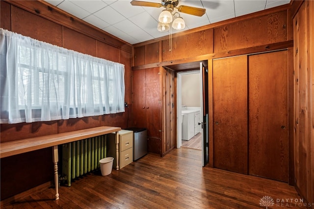 654 S Market St, Troy, OH 45373 - unfurnished office with separate washer and dryer, hardwood / wood-style floors, ceiling fan, wooden walls, and radiator heating unit