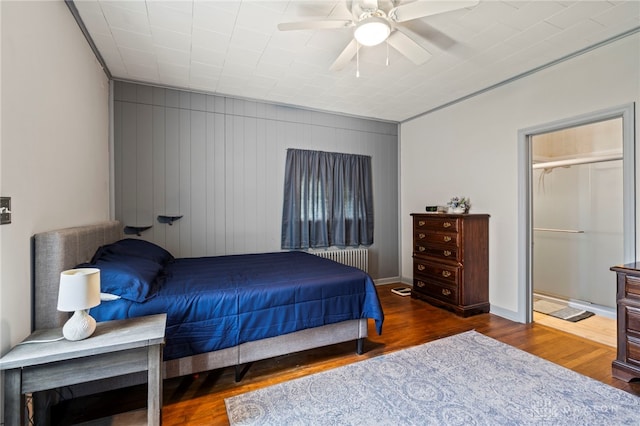654 S Market St, Troy, OH 45373 - bedroom featuring radiator, wood finished floors, ceiling fan, and baseboards