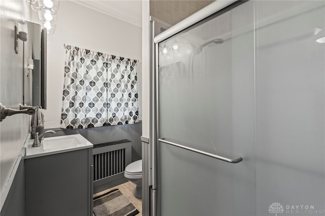 654 S Market St, Troy, OH 45373 - full bath with radiator heating unit, a stall shower, toilet, vanity, and ornamental molding