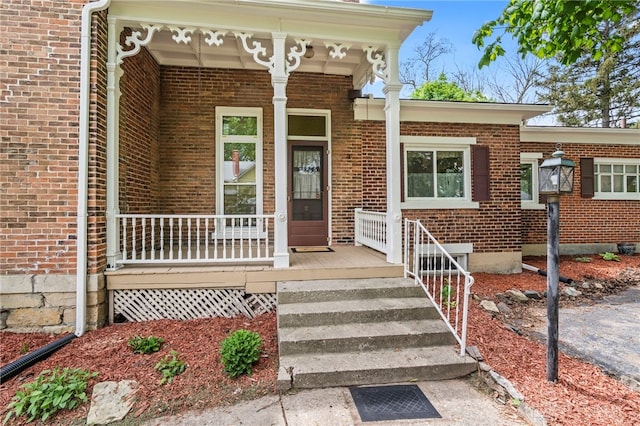 654 S Market St, Troy, OH 45373 - property entrance featuring a porch and brick siding