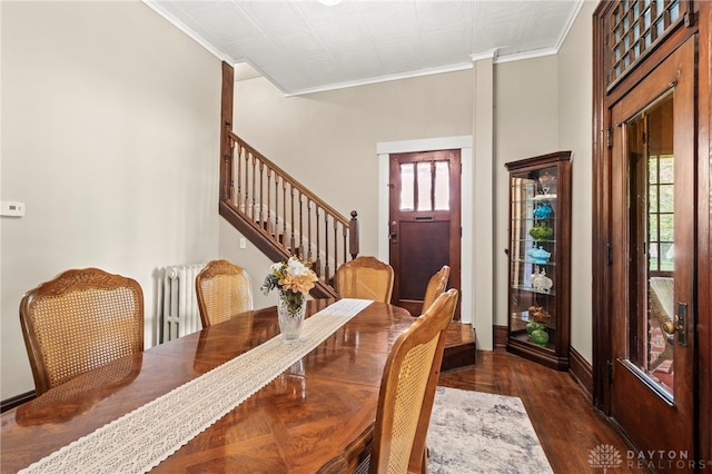 654 S Market St, Troy, OH 45373 - dining room with stairway, crown molding, dark wood-style floors, baseboards, and radiator