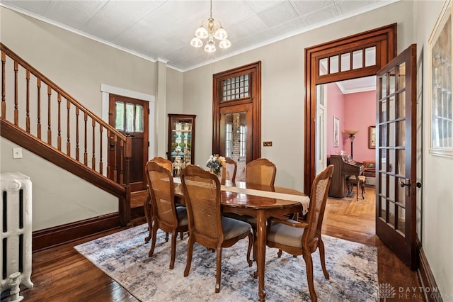 654 S Market St, Troy, OH 45373 - dining room featuring radiator heating unit, a chandelier, french doors, stairs, and baseboards