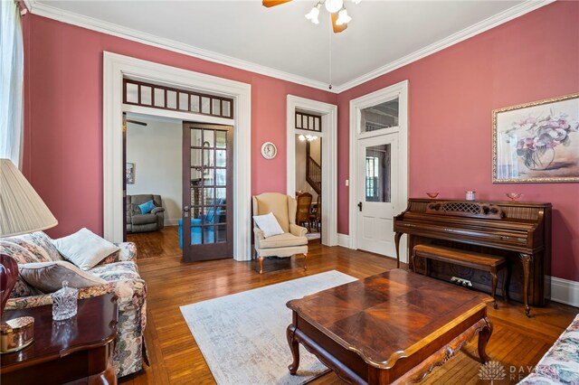 654 S Market St, Troy, OH 45373 - living area with a ceiling fan, wood finished floors, crown molding, and healthy amount of natural light