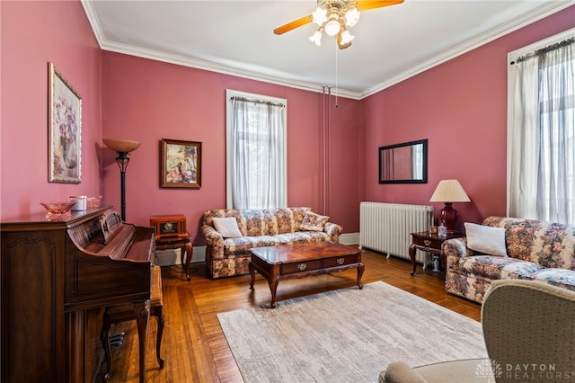 654 S Market St, Troy, OH 45373 - living room featuring radiator heating unit, ceiling fan, ornamental molding, and baseboards