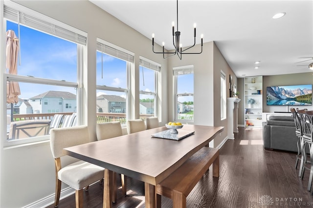 1591 Windham Ln, Beavercreek Township, OH 45385 - dining space featuring a chandelier, wood finished floors, recessed lighting, baseboards, and built in shelves