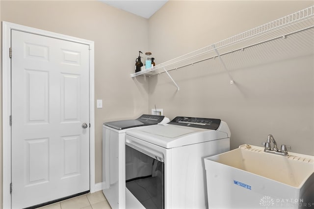 1591 Windham Ln, Beavercreek Township, OH 45385 - clothes washing area with washer and clothes dryer, light tile patterned floors, and baseboards