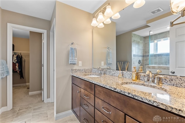 1591 Windham Ln, Beavercreek Township, OH 45385 - bathroom featuring walk in shower, double vanity, baseboards, and a walk in closet