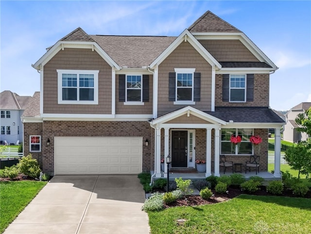 1591 Windham Ln, Beavercreek Township, OH 45385 - craftsman house featuring a porch, a garage, concrete driveway, and brick siding
