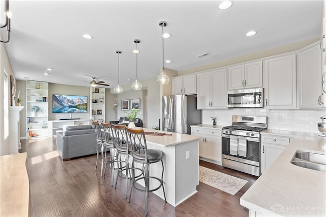 1591 Windham Ln, Beavercreek Township, OH 45385 - kitchen with stainless steel appliances, open floor plan, a center island, ceiling fan, and light countertops