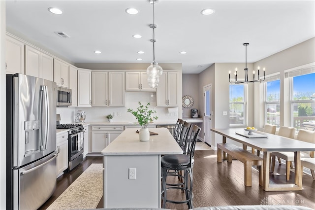 1591 Windham Ln, Beavercreek Township, OH 45385 - kitchen featuring appliances with stainless steel finishes, dark wood-type flooring, recessed lighting, light countertops, and white cabinetry