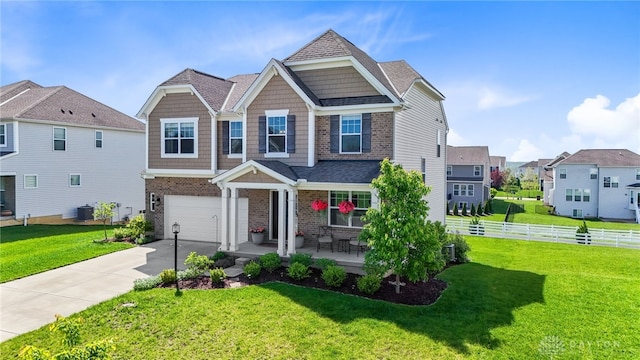 1591 Windham Ln, Beavercreek Township, OH 45385 - craftsman inspired home featuring brick siding, a garage, concrete driveway, a porch, and central AC unit