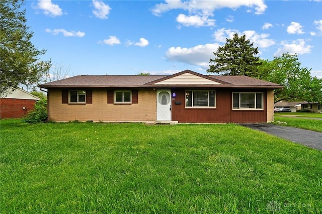 ranch-style home featuring a front yard