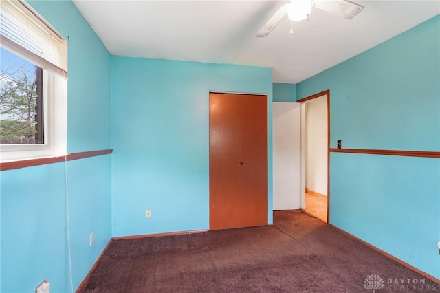 unfurnished bedroom with carpet and a closet