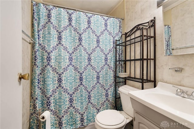 full bathroom with tile walls, toilet, vanity, and a shower with curtain