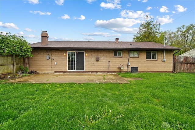 back of property featuring a chimney, brick siding, a patio, and cooling unit