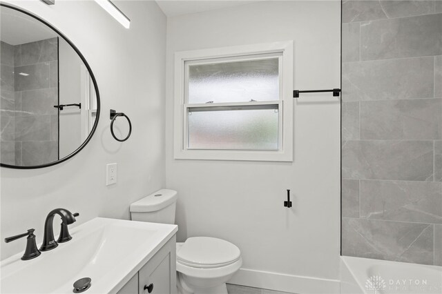 full bathroom with toilet and vanity