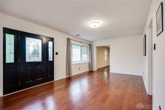 foyer entrance with wood finished floors and baseboards