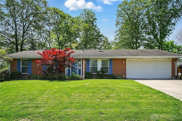 3352 Morning Glory Rd, Dayton, OH 45449 - view of front of home with a garage, driveway, brick siding, and a front yard