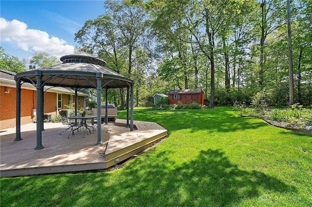3352 Morning Glory Rd, Dayton, OH 45449 - view of grassy yard with a gazebo, a storage shed, a deck, and an outbuilding