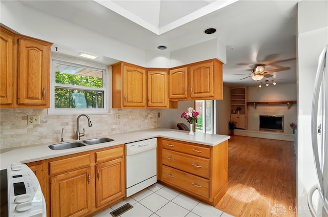 3352 Morning Glory Rd, Dayton, OH 45449 - kitchen with white dishwasher, a sink, a peninsula, a ceiling fan, and open floor plan