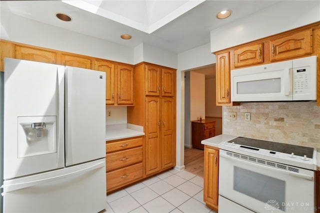 3352 Morning Glory Rd, Dayton, OH 45449 - kitchen with white appliances, light countertops, decorative backsplash, light tile patterned floors, and brown cabinets