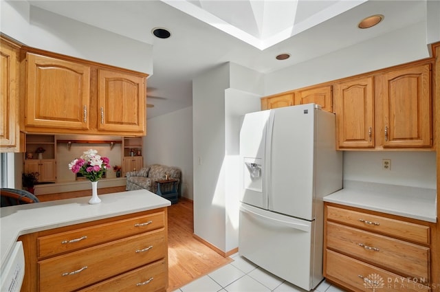 3352 Morning Glory Rd, Dayton, OH 45449 - kitchen with white fridge with ice dispenser, light countertops, light tile patterned flooring, a skylight, and brown cabinetry