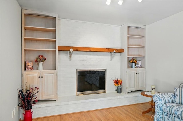 3352 Morning Glory Rd, Dayton, OH 45449 - living room featuring a brick fireplace and wood finished floors