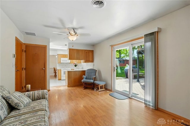 3352 Morning Glory Rd, Dayton, OH 45449 - living area featuring light wood-type flooring, a ceiling fan, and baseboards