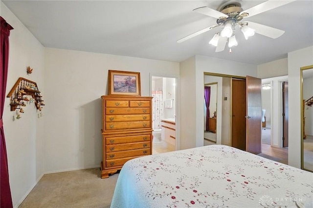 3352 Morning Glory Rd, Dayton, OH 45449 - bedroom with light carpet, ensuite bath, ceiling fan, and baseboards