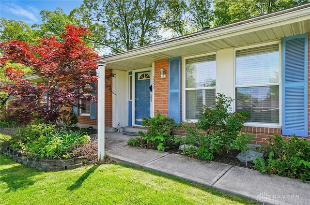 3352 Morning Glory Rd, Dayton, OH 45449 - view of exterior entry with brick siding and a lawn