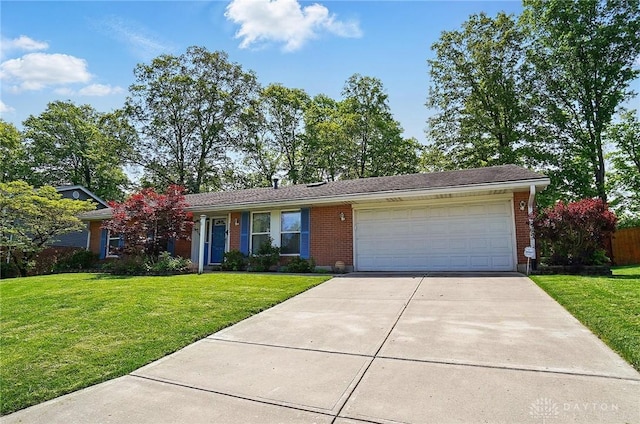 3352 Morning Glory Rd, Dayton, OH 45449 - view of front of home featuring a garage, brick siding, a front lawn, and driveway