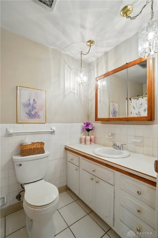 3352 Morning Glory Rd, Dayton, OH 45449 - bathroom featuring a chandelier, tile walls, toilet, vanity, and tile patterned floors