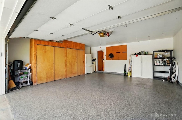 3352 Morning Glory Rd, Dayton, OH 45449 - garage featuring freestanding refrigerator and a garage door opener