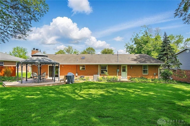 3352 Morning Glory Rd, Dayton, OH 45449 - back of house featuring a gazebo, a lawn, brick siding, and a patio